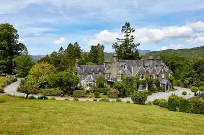 an estate in the hills with a large yard at Penmaenuchaf Hotel in Dolgellau