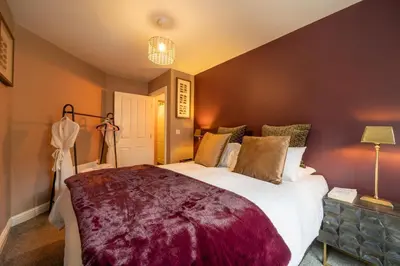 a bedroom with a large bed in a room at At Home Apartments in Shrewsbury
