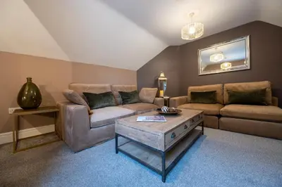 a living room with a couch and a coffee table at At Home Apartments in Shrewsbury