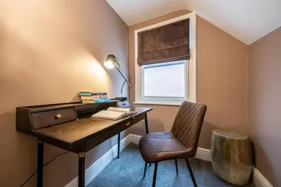 a desk and a chair in a room with a window at At Home Apartments in Shrewsbury