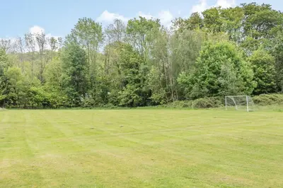 an open field with a soccer goal in it at Robin Lodge in Llanbedr