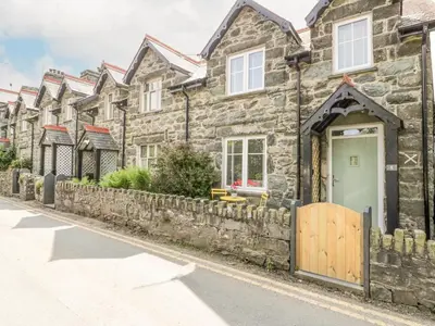 a row of stone houses on a street at Y Bwthyn in Llanbedr