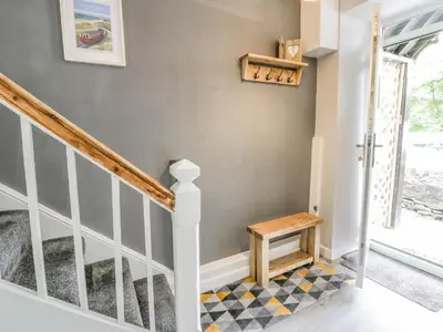 a staircase in a house with a checkered floor at Y Bwthyn in Llanbedr
