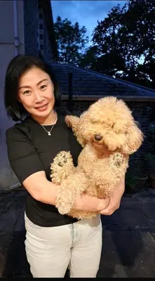 a woman holding a stuffed dog in her arms at Pippin Lodge in Llanwrda