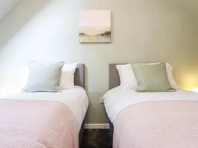 two beds sitting next to each other in a room at Ysgubor Craig Y Gronfa in Machynlleth