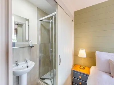 a bathroom with a shower and a sink at The Stables in Forden