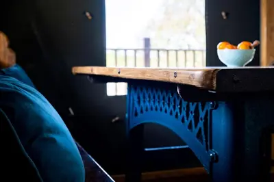 a table with a bowl of oranges on it at Canvas & Campfires, Luxury Safari Tent Glamping, only Seren Tent has a hot tub in Lampeter