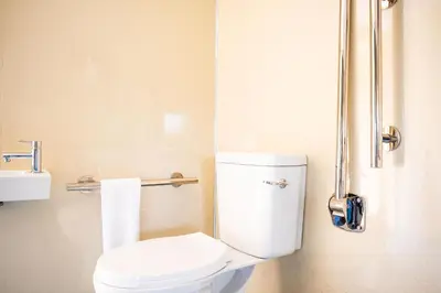 a small bathroom with a toilet and a sink at Canvas & Campfires, Luxury Safari Tent Glamping, only Seren Tent has a hot tub in Lampeter