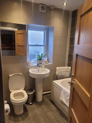 a bathroom with a toilet and a sink and a tub at Snowdon view, steam railway & Portmeirion nearby in Mynfford
