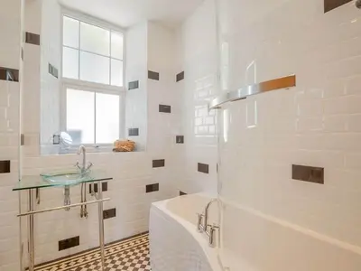 a white bathroom with a tub and a sink at Rockcliffe in Aberdyfi