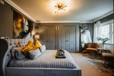 a living room with a large bed and a ceiling at Boutique Shrewsbury Rooms in Shrewsbury