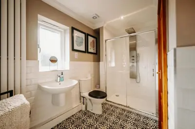 a bathroom with a toilet and a sink and a shower at Boutique Shrewsbury Rooms in Shrewsbury