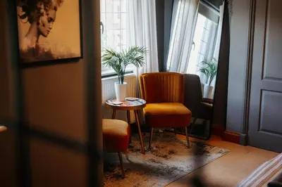 a room with a table and a chair and a window at Boutique Shrewsbury Rooms in Shrewsbury
