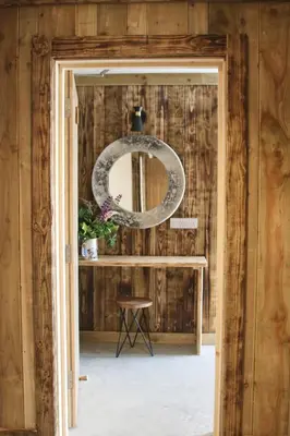 a room with a mirror and a table at The Moo-tel at Moody Meadows in Aberaeron
