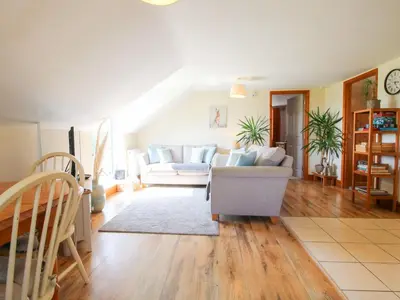 a living room with a couch and a table at Mossy Lodge in Shrewsbury