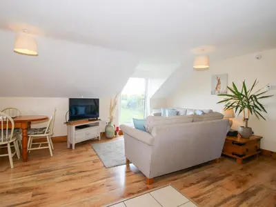 a living room with a couch and a table at Mossy Lodge in Shrewsbury