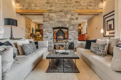 a living room with a couch and a fireplace at Hilltop View with Hot Tub in Brecon