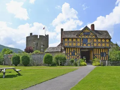 an old building with a castle and a picnic table at Walkmill Lodge in Wentnor