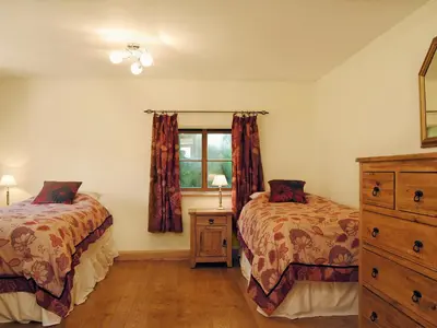 a bedroom with two beds and a window at Mashers Barn in Bucknell