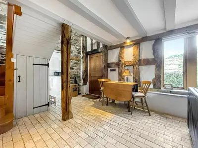 a kitchen with a table and chairs and a tub at Meadow Barn in Shelve
