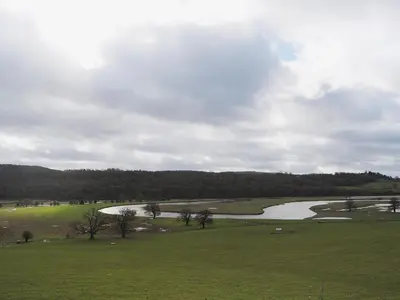 a view of a golf course with a river at Meadow Barn in Shelve