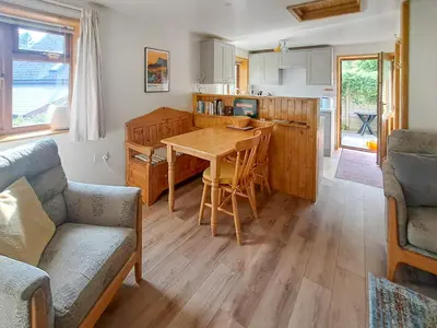 a kitchen with a wooden table in a room at Garden Lodge in Llanvair Waterdine