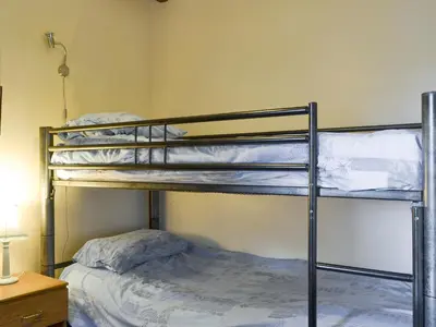 a bedroom with two bunk beds in a room at Grove Sprightly Barn in Craven Arms