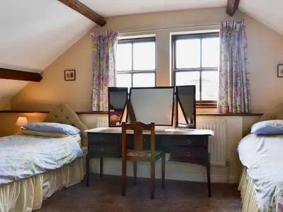 a bedroom with a desk and a mirror at Halford Big Barn in Halford