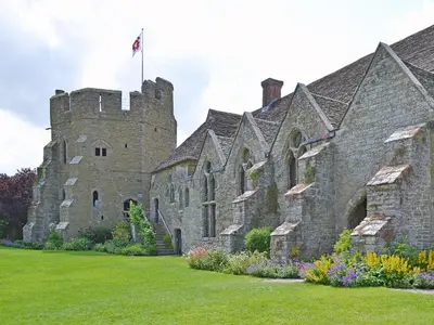 an old castle with a flag on top of it at Halford Big Barn in Halford