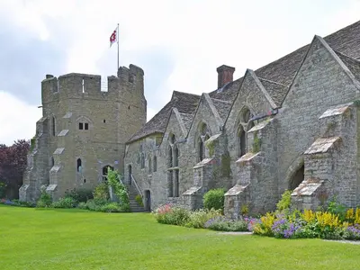 an old castle with a flag on top of it at Dinhope Big Barn in Craven Arms