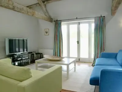 a living room with a couch and a tv at Cow Shed in Farden
