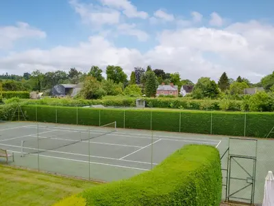 a tennis court with a net on top of it at The Stables in Eardisland