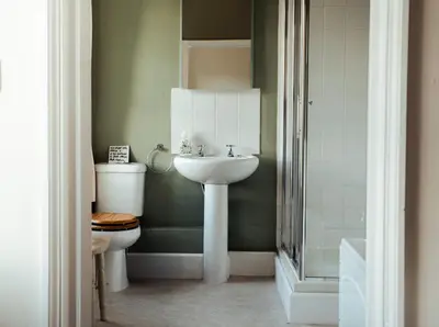 a bathroom with a sink and a toilet at Stone House Wales in Kington