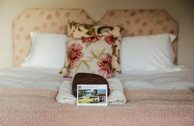 a book sitting on top of a bed at Stone House Wales in Kington