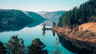 a view of a bridge over a body of water at Lake Vyrnwy Hotel & Spa in Llanwddyn