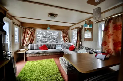 a living room with a couch and a table at Ideal rural location for beaches, hills and town in Bow Street