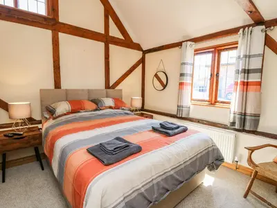 a bedroom with a bed with towels on it at Awelfan in Newtown