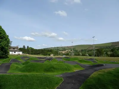 a skate park with a skateboard ramp in the grass at Glan Wye in Rhayader