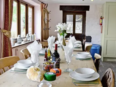 a dining room table with plates and wine glasses at The Bailey in Glasbury