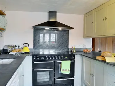 a kitchen with a black stove top oven at The Bailey in Glasbury
