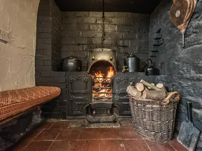 a brick oven with pots and pans in a room at Pen Copi in Trefeglwys
