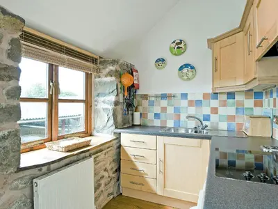 a small kitchen with a sink and a window at Llofft Stabal in Llanerfyl