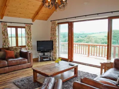 a living room with a couch and a tv at The Farmhouse in Mydroilin
