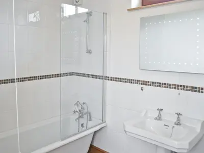 a bathroom with a shower and a sink at The Farmhouse in Mydroilin