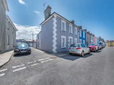 a street with cars parked on the side of a building at Glendower in Aberaeron