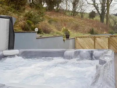 a jacuzzi plunge in a backyard with at Beudy-Oh2 in Dihewid