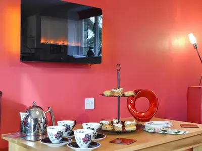 a table with cupcakes on a stand in a room at Cartws-Oh3 in Dihewid