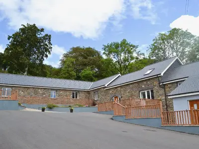 a brick building with a fence on a street at Stabl-Oh4 in Dihewid
