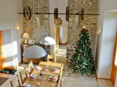 a christmas tree in the middle of a dining room at Felin Hedd Peaceful Mill in Tregaron