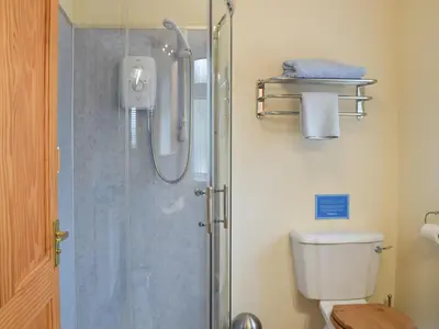 a bathroom with a shower and a toilet at Penybryn in Llansadwrn